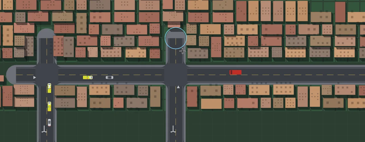 Flat planner view of the same town: residential and commercial blocks packed along the roads, a few cars moving.
